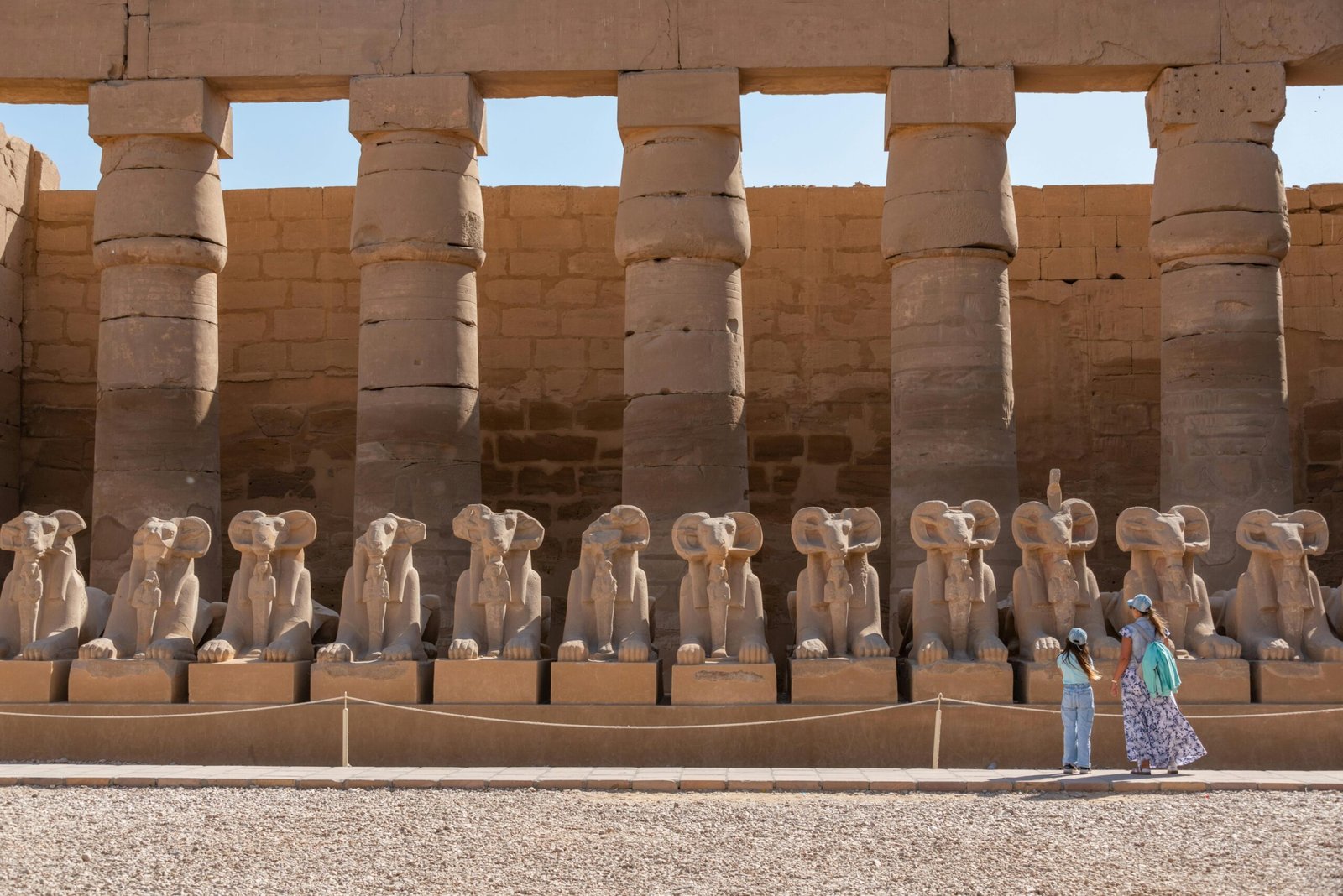 A captivating view of Luxor Temple, with towering columns and intricate carvings illuminated by soft sunlight