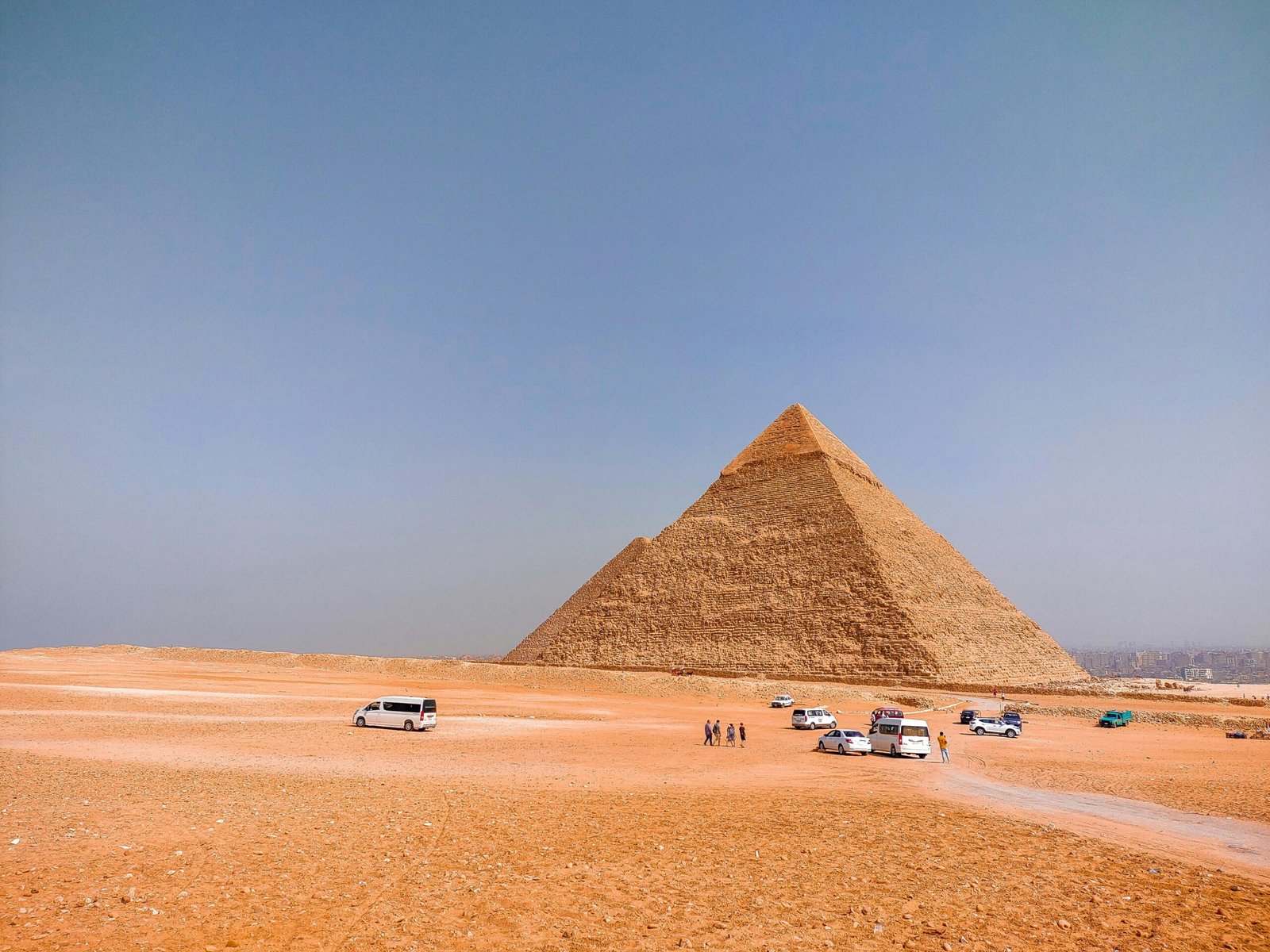 A breathtaking view of the Pyramids of Giza and the Sphinx against the backdrop of the desert landscape, showcasing the timeless beauty of Egypt's ancient wonders.